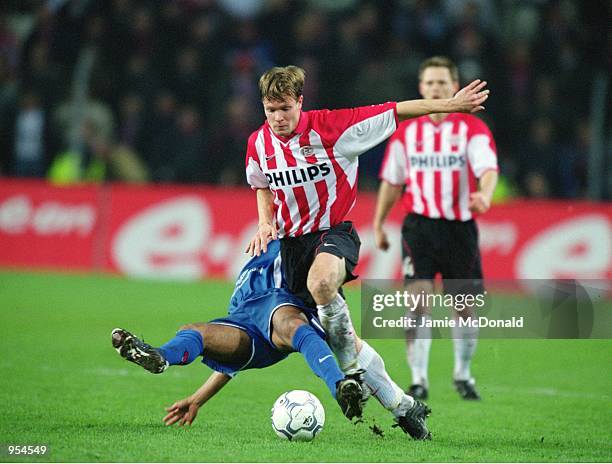 Joonas Kolkka of PSV Eindhoven shrugs off the challenge from Ratinho of Kaiserslautern during the UEFA Cup Quarter Finals second leg match played at...
