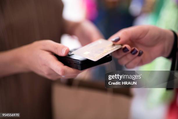 customer doing credit card payment to saleswoman - cosmetics counter stock pictures, royalty-free photos & images