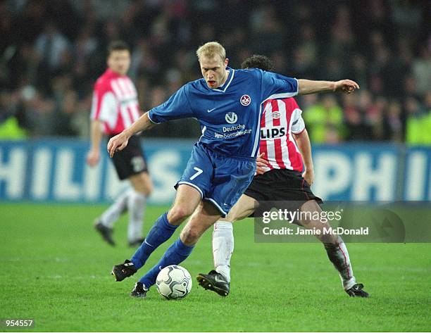 Marian Hristov of Kaiserslautern beats Mark Van Bommel of PSV Eindhoven during the UEFA Cup Quarter Finals second leg match played at the Philips...