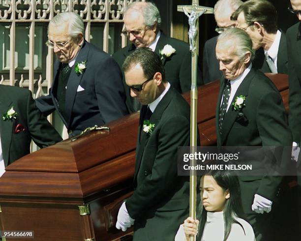 The casket of baseball great Joe DiMaggio is carried down the steps of Saint's Peter and Paul Parish by friends and family members including his son...