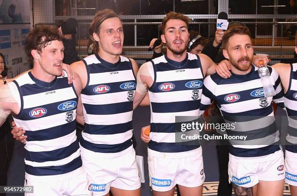 Jed Bews, Jake Kolodjashnij, Jackson Thurlow and Zach Tuohy of the Cats sing the song in the rooms after winning the round seven AFL match between...