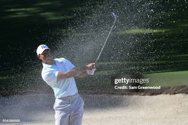 Tiger Woods plays his second shot from a bunker on the 14th hole during the second round of the 2018 Wells Fargo Championship at Quail Hollow Club on...