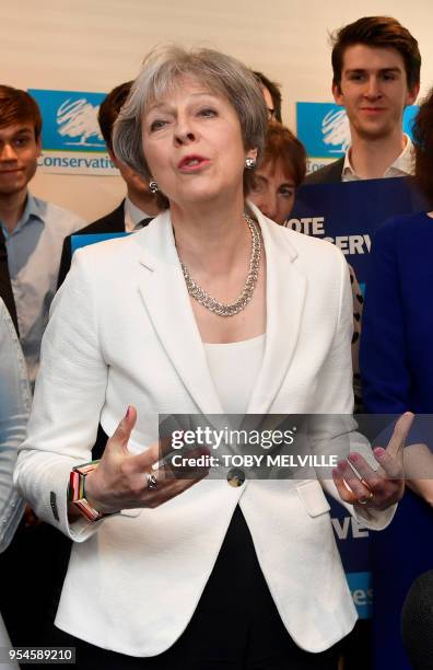 Britain's Prime Minister Theresa May speaks during a visit to Finchley Conservatives in Barnet, north London after the Conservative party retained...