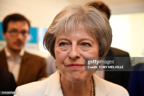 Britain's Prime Minister Theresa May speaks during a visit to Finchley Conservatives in Barnet, north London after the Conservative party retained...