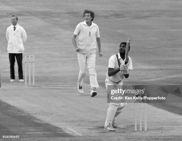 West Indies batsman Michael Holding and England bowler Bob Willis watch as Paul Allott of England takes the catch to dismiss Holding and give Willis...