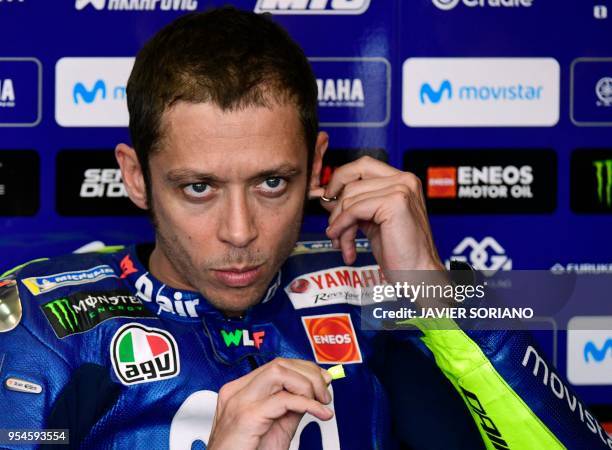 Movistar Yamaha MotoGP's Italian rider Valentino Rossi tuoches his earring as he waits for the the second MotoGP free practice session of the Spanish...