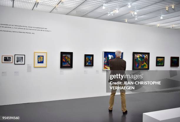 Visitor looks at pieces of art by the couple Vassily Kandinsky and Gabriele Münter during the exhibition "Couples modernes" on May 4, 2018 at the...