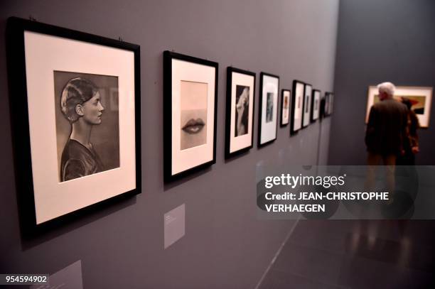 Visitor looks at pieces of art by the couple Man Ray and Lee Miller during the exhibition "Couples modernes" on May 4, 2018 at the Centre...
