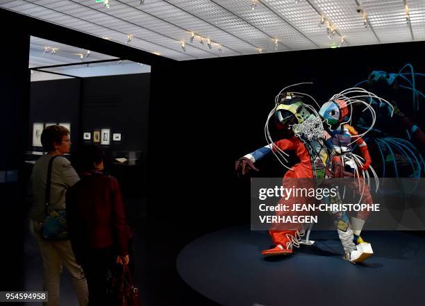 Visitor looks at pieces of art by the couple of artists Walter Holdt and Lavinia Schulz during the exhibition "Couples modernes" on May 4, 2018 at...