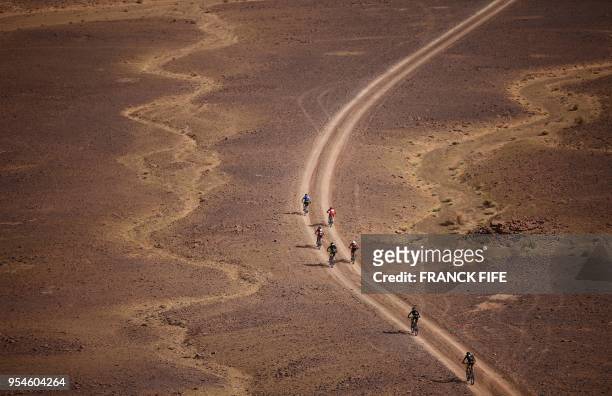 Competitors ride their bikes during stage 6 of the 13th edition of the Titan Desert 2018 mountain biking race between Merzouga and Maadid on May 4,...