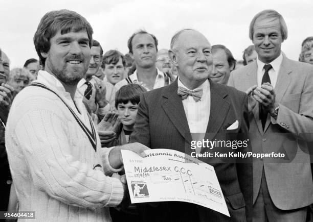 Middlesex captain Mike Gatting is presented with a prize cheque for winning the County Championship after Middlesex won the Britannic Assurance...