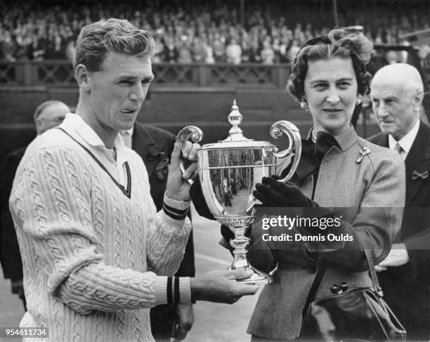 Australian tennis player Frank Sedgman receives a cup from the Duchess of Kent after beating Jaroslav Drobny on the Centre Court at Wimbledon, to win...