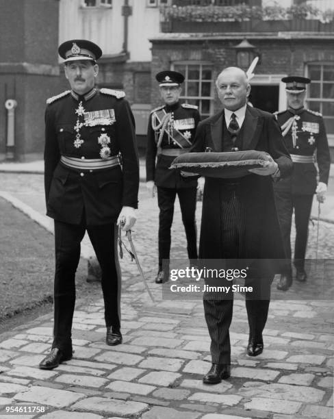 Lieutenant-General Sir Oliver Leese , Lieutenant of the Tower, and Roger Lumley, 11th Earl of Scarbrough , the Lord Chamberlain, perform the...