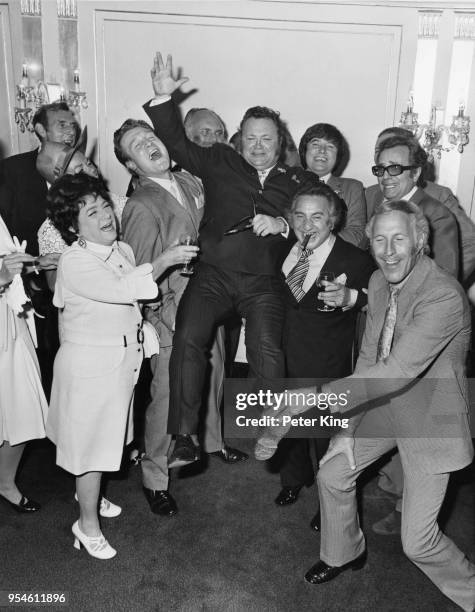 Welsh comedian and singer Harry Secombe is lifted up by his colleagues at a Variety Club of Great Britain luncheon in his honour at the Dorchester...