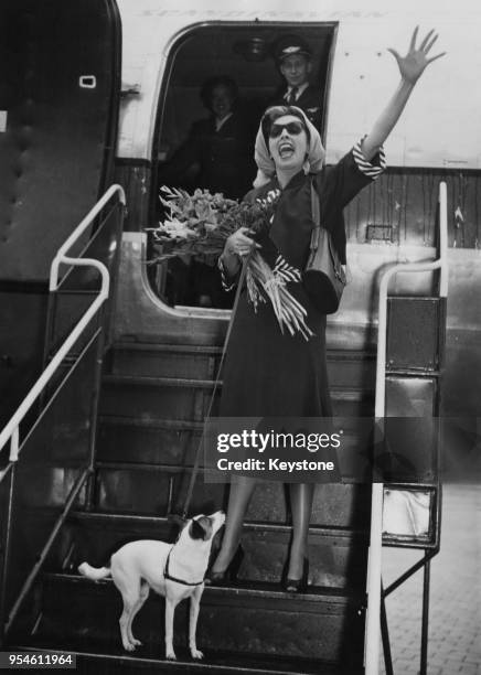 Chilean singer Rosita Serrano arrives in Munich on her way to Hamburg to begin her concert tour of Germany, 17th September 1951. She is accompanied...