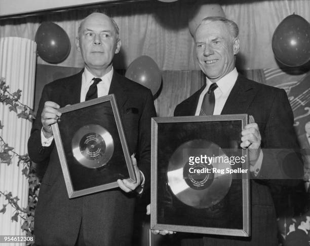 English bandleader Victor Silvester receives a platinum record and a silver long-playing record from Sir Joseph Lockwood , Director of EMI, in...