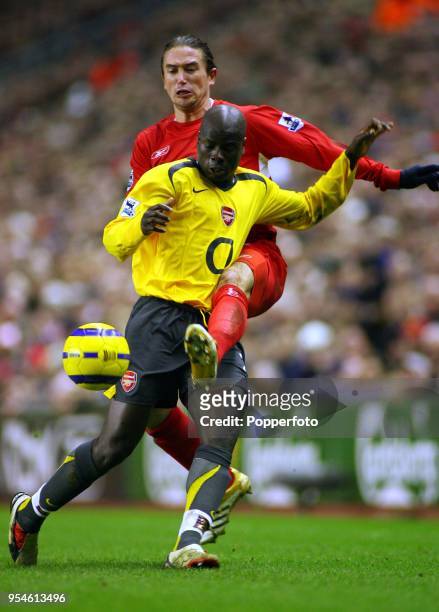 Emmanuel Eboue of Arsenal and Harry Kewell of Liverpool in action during the Barclays Premiership match between Liverpool and Arsenal at Anfield in...