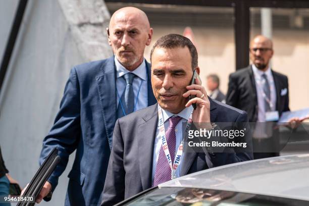 Amos Genish, chief executive officer of Telecom Italia SpA, speaks on a mobile phone as he leaves following an extraordinary shareholders' meeting at...