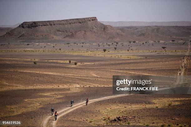 Competitors ride their bikes during stage 6 of the 13th edition of the Titan Desert 2018 mountain biking race between Merzouga and Maadid on May 4,...