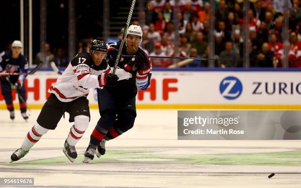 Anders Lee of United States and Jaden Schwartz of Canada battle for the puck during the 2018 IIHF Ice Hockey World Championship group stage game...