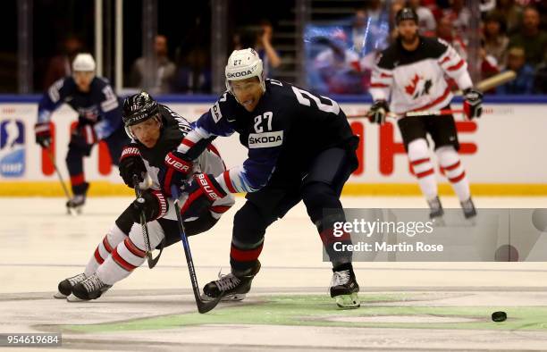 Anders Lee of United States and Jaden Schwartz of Canada battle for the puck during the 2018 IIHF Ice Hockey World Championship group stage game...