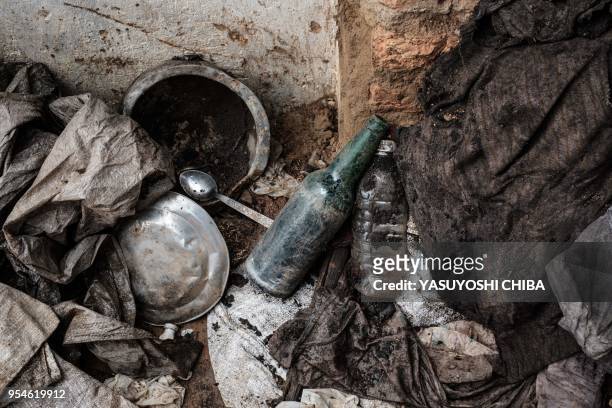 Picture taken on April 30 shows victims' items collected from a pit which was used as mass grave during 1994 Rwandan genocide and hidden under a...
