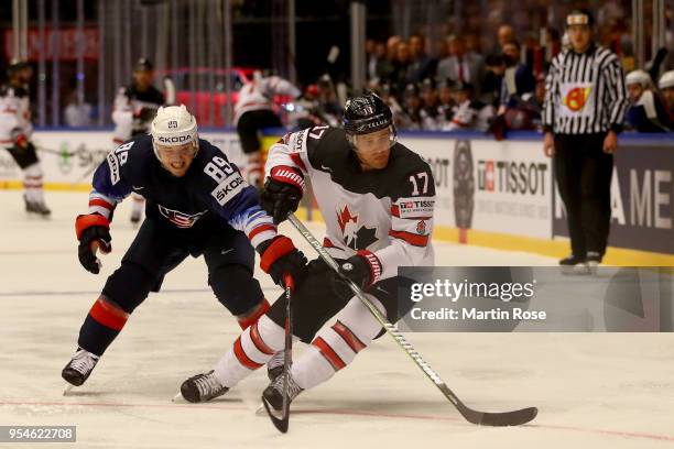 Cam Atkinson of United States and Jaden Schwartz of Canada battle for the puck during the 2018 IIHF Ice Hockey World Championship group stage game...