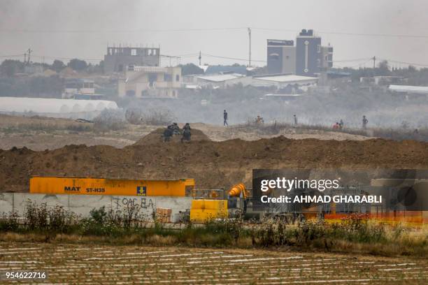 Israeli soldiers take position along with border with the Gaza strip near the southern Israeli kibbutz of Nahal Oz on May 4 during clashes with...