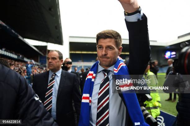 Former England and Liverpool captain Steven Gerrard gestures as he is introduced to supporters inside Ibrox stadium after being unveiled as Rangers'...