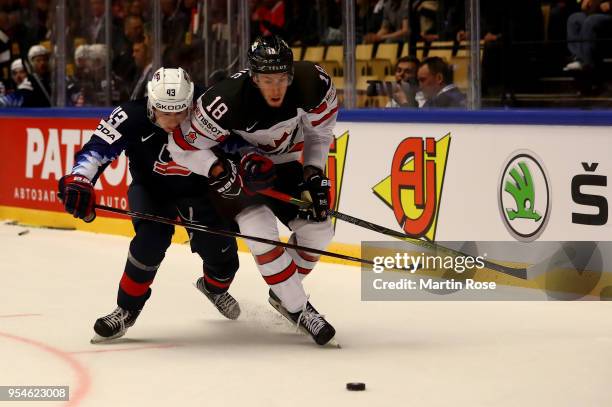 Quinn Hughes of United States and Pierre Luc Dubois of Canada battle for the puck during the 2018 IIHF Ice Hockey World Championship group stage game...