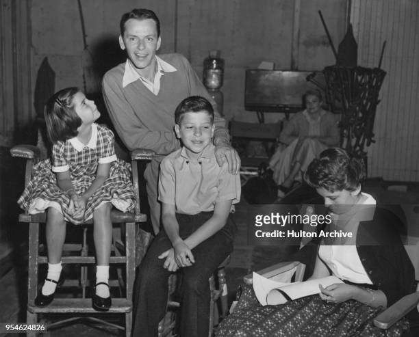American singer and actor Frank Sinatra with his three children Christina, Nancy and Frank Jr on the set of the film 'The Tender Trap', circa 1955.