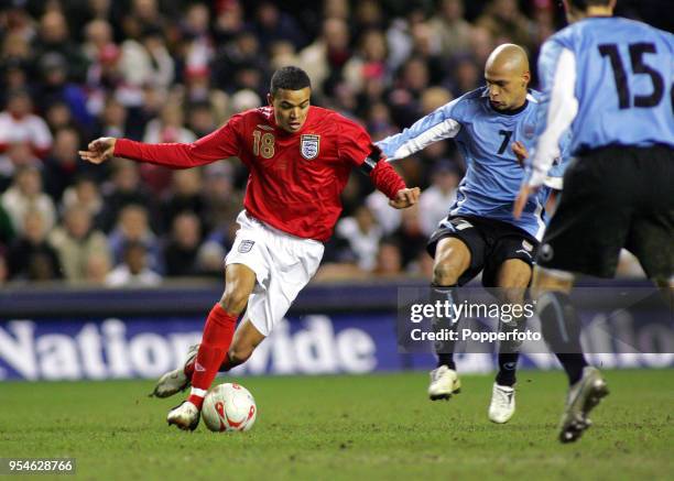 Jermaine Jenas of England is challenged by Gustavo Varela of Uruguay during the International friendly match between England and Uruguay at Anfield...