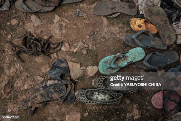 Picture taken on April 28, 2018 shows the victims' items on the ground after being collected from a pit which was used as mass grave during 1994...