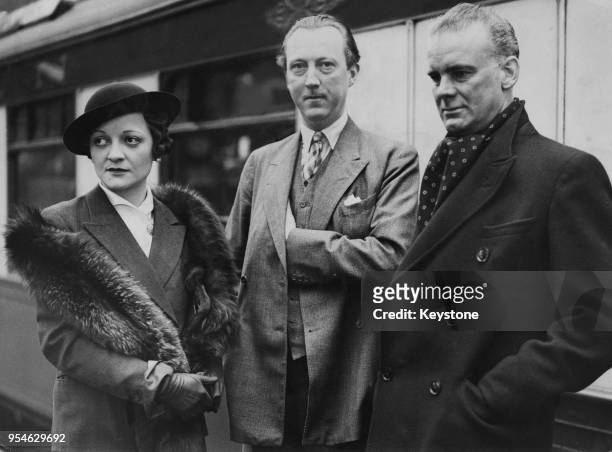 English writer Sacheverell Sitwell , his wife Georgia and artist Richard Wyndham at Waterloo Station, before leaving on the 'Almanzora' boat train...