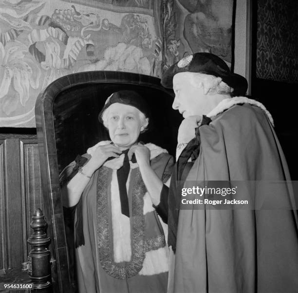 British politician Beatrice Seear adjusts her robes before being created a Life Peer at the House of Lords, as Baroness Seear of Paddington in the...