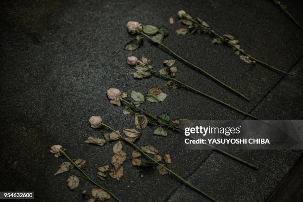 Picture taken on April 29, 2018 shows flower offerings on a mass grave at the Kigali Genocide Memorial in Kigali, Rwanda. - According to the main...