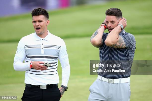 Keith Duffy and Gary Beadle react on the 6th green during the Pro Am event prior to the start of GolfSixes at The Centurion Club on May 4, 2018 in St...