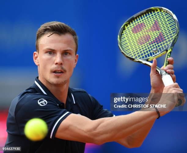 Hungary's Marton Fucsovics returns the ball to Germany's Maximilian Marterer during their quarter final match at the ATP tennis BMW Open in Munich,...