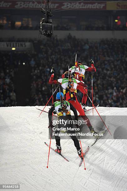 Michael Greis of Germany, Dominik Landertinger of Austria and Christoph Sumann of Austria compete during the Biathlon World Team Challenge WTC...