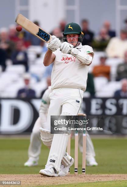 Jake Ball of Nottinghamshire smashes the ball to the boundary during the Specsavers County Championship Division One match between Nottinghamshire...