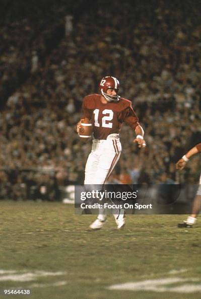 Alabama Crimson Tide's quarterback Joe Namath steps back and looks for a receiver during a game.