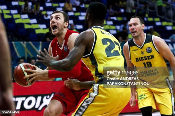 Riesen Ludwigsburg's Elgin Cook vies for the ball with AS Monaco's Damjan Rudez during the final four Champions League basketball game between Riesen...