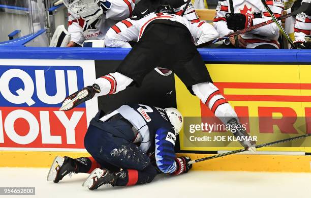 Canada's Aaron Ekblad and United States' Connor Murphy crash against the boards during the group B match US vs Canada of the 2018 IIHF Ice Hockey...