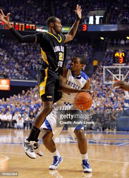 Darius Miller of the Kentucky Wildcats shoots the ball while defended by Larry Anderson of the Long Beach State 49ers during the game at Rupp Arena...