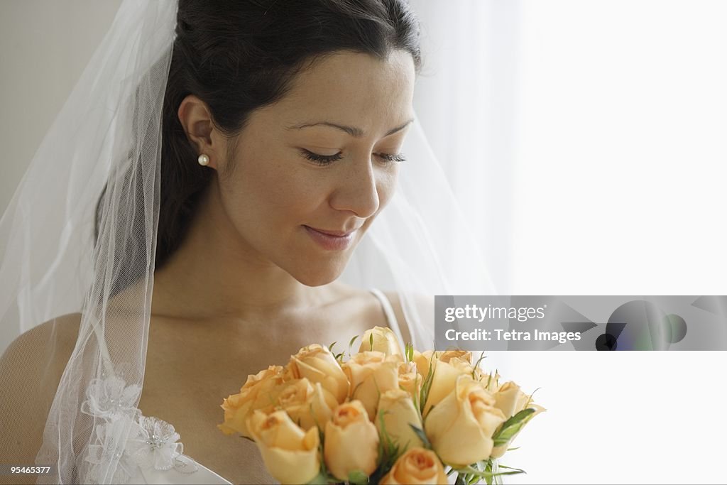 A bride looking down at her bouquet