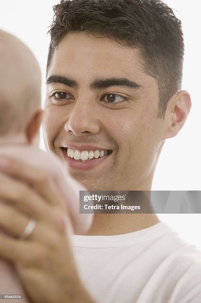 A man holding up a baby