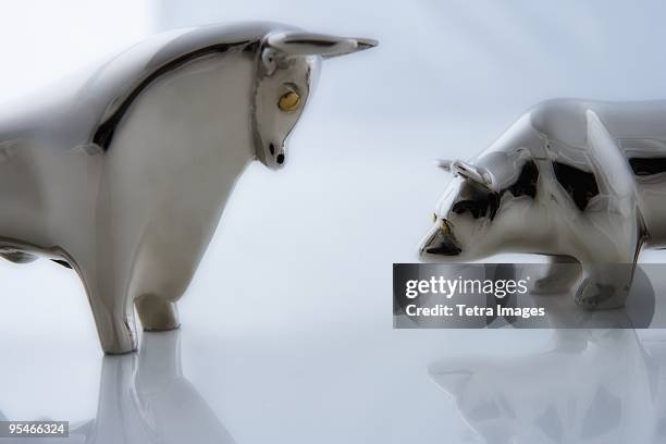 metal animal figurines - charging bull statue stock pictures, royalty-free photos & images