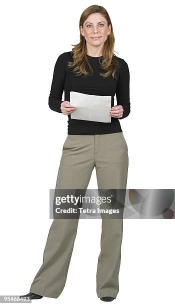 a woman standing with a paper in her hands - female full length stock pictures, royalty-free photos & images
