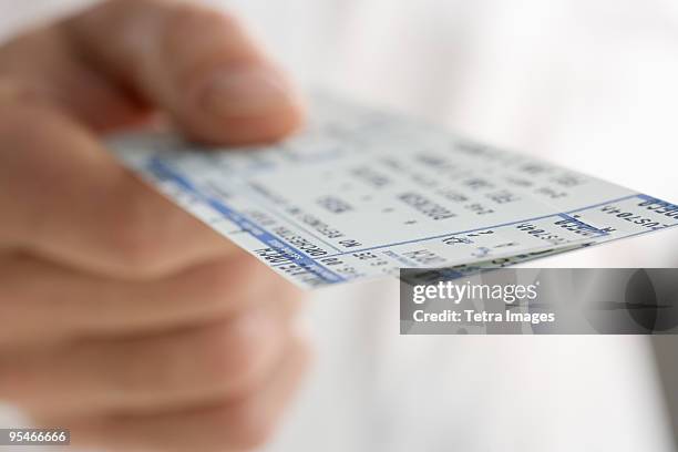 hand holding a ticket - entrada de cine fotografías e imágenes de stock