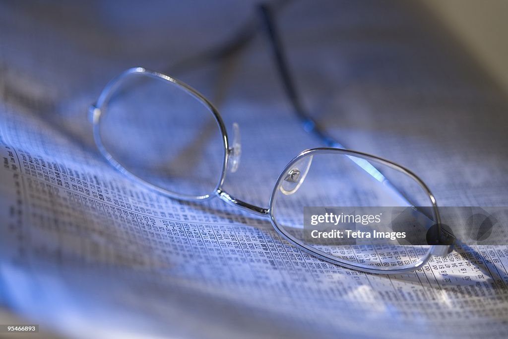 Reading glasses on newspaper